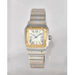 A Cartier Santos yellow gold and steel curved square cased bracelet wristwatch,