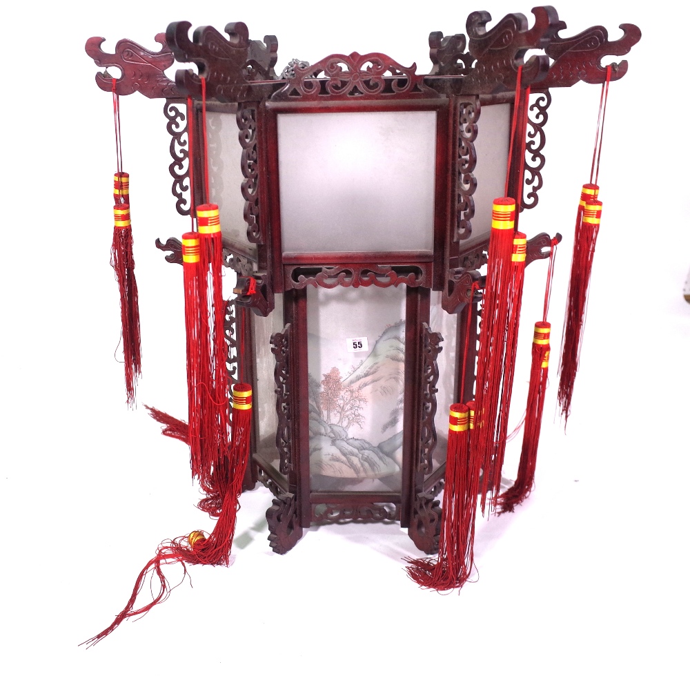 A modern Chinese hanging lantern with carved hardwood octagonal frame,