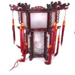 A modern Chinese hanging lantern with carved hardwood octagonal frame,