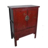 An early 20th century red laqueur Chinese side cabinet, 95cm wide x 46cm deep x 175cm high.