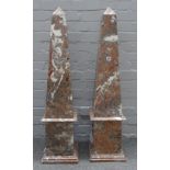 A pair of large rouge marble obelisks, on stepped plinth bases, 104cm high, (2).