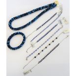 Three silver and treated sapphire set bracelets, a silver and sapphire set seven stone bracelet,