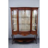 An Edwardian inlaid mahogany bowfront display cabinet with single door over drawer on cabriole