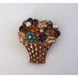 A 9ct gold and gem set brooch, designed as a basket of flowers, mounted with blue zirzon, amethyst,