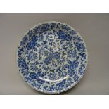 A Chinese blue and white dish, Kangxi, painted with branches of flowering peony, 35.5cm. diameter.