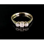 A gold and diamond three stone diamond r