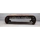 A late 19th century Chinese carved hardwood low table 101cm wide x 31cm high together with a nest