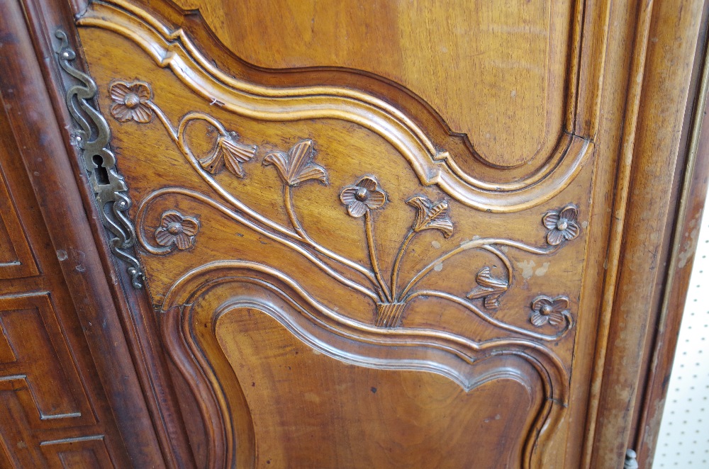 An 18th century fruitwood armoire with carved arched cornice over a pair of shaped panel doors, - Image 2 of 7