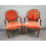 A pair of George III style beech framed open armchairs, on channelled tapering square supports,