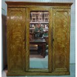 A Victorian satin birch compactum wardrobe with centre mirrored door, 188cm wide x 209cm high.