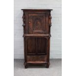 A 17th century design side cabinet, with single door with carved figural mounts,