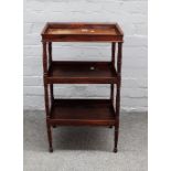 A Charles X rosewood three-tier étagère with rectangular tray top on ring-turned supports,