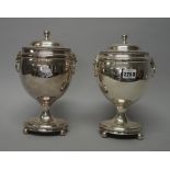 A pair of silver plate vase and covers in the Regency Style,