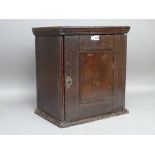 An early 18th century oak hanging spice cupboard,