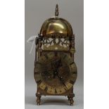 A 19th century brass lantern clock enclosing a French two train movement, 31cm high.