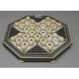 An early 20th century Indian ivory solitaire board of octagonal form,