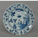 An English delftware blue and white plate, mid-18th century, painted with an insect,