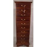 A 20th century mahogany tall chest of ten single drawers on bracket supports,