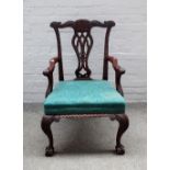 A mid-18th century style carved mahogany framed open armchair on claw and ball feet,