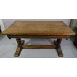 An 18th century style oak draw leaf dining table on turned bulbous carved supports,
