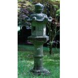 A Japanese carved stone garden lantern, 19th/20th century, on pedestal, 174cms high.