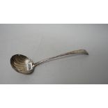 A George III Irish silver 18th century soup ladle, the bowl with partly fluted decoration,