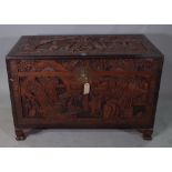 An early 20th century Chinese carved camphorwood trunk, on winged beast supports,