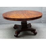 A George IV mahogany centre table, the circular snap top on quatrefoil platform and scroll feet,
