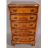 A George III style walnut chest of five graduated drawers on bracket feet, 53cm wide x 94cm high.