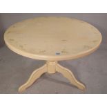 A 20th century cream painted circular dining table, 103cm wide x 77cm high.