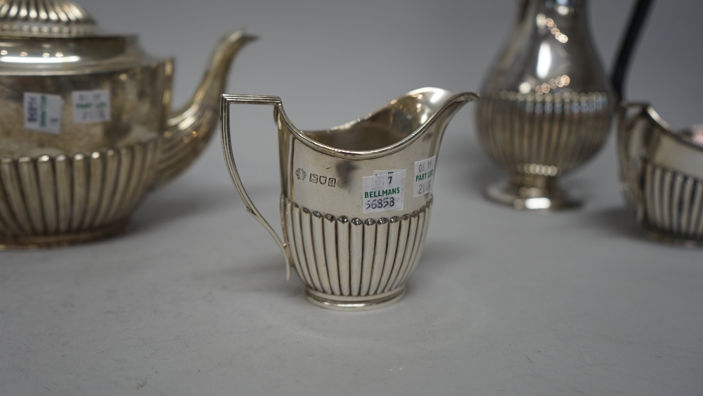 A silver composite four piece tea set, comprising; an oval teapot, with black composition fittings, - Image 4 of 6