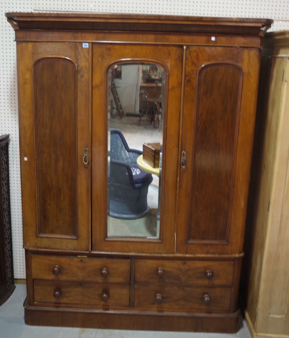 A Victorian mahogany triple wardrobe with mirrored door on plinth base. - Image 2 of 2