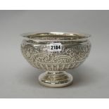A late Victorian silver bowl, of circular form, the body embossed with a wide floral,