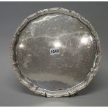 A George V silver salver, of shaped circular form, with Celtic motif border,