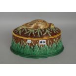 A George Jones majolica pie dish, the oval lid with dead partridge decoration,