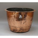 A copper log basket, 19th century, with rivetted band to the base and an out turned rim,