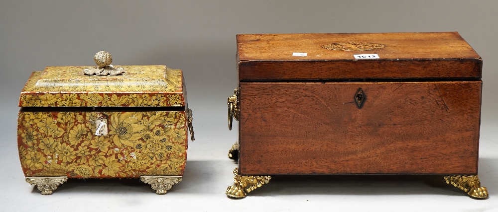 A George III mahogany rectangular tea caddy on gilt metal paw feet,