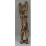 A Dogan tribal wooden figure, depicted standing with arms outstretched (a.f), 71cm high.