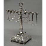 A silver musical menorah, mounted with a Star of David,