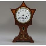 An Edwardian mahogany cased mantel clock with Art Nouveau style inlay and a shaped 'crown'