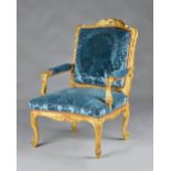 An 18th century French gilt framed open armchair/ fauteuil with acanthus carved scrolling frame