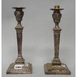 Two similar Victorian silver table candlesticks, each with a tapered stem, raised on a square base,