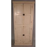 A 20th century cream painted side cabinet with panelled doors, 80cm wide x 182cm high.