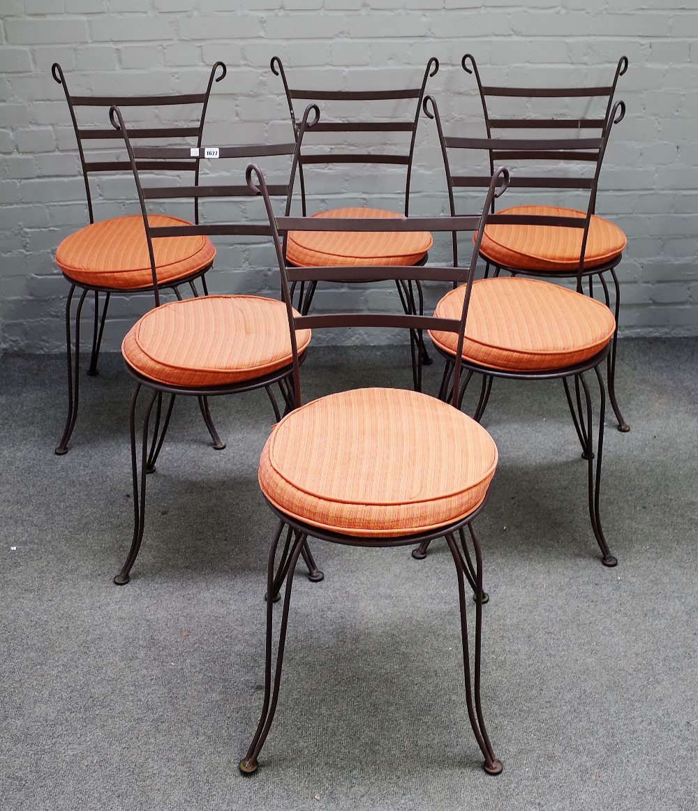 A set of fourteen wrought iron gardens chairs, with splayed ladder backs and supports,