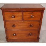 A Victorian mahogany chest of two short and two long drawers with bun handles,