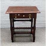 A 17th century oak single drawer side table on bobbin turned supports, 68cm wide x 72cm high.