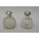 Two silver hinge lidded faceted glass globular scent bottles, of differing designs,