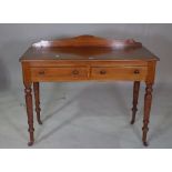 A Victorian mahogany two drawer side table, with galleried back on ring turned supports.