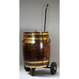 A coopered brass and oak ice bucket on wheeled stand, the bucket 35cm diameter x 43cm high.
