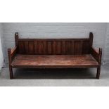A large bench/dog bed, constructed from 18th century timber with panel back and block supports,